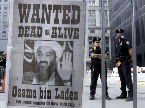 bin laden please stand up. Police stand near a wanted