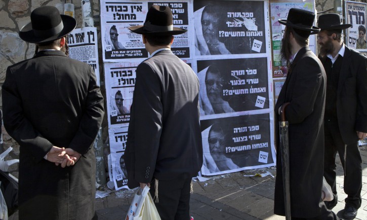 Campaign posters for Shas party in Jerusalem Ultra-Orthodox Jews reading election posters by the ultra-Orthodox Shas party in a religious neighborhood in Jerusalem, 18 January 2013. The posters show the spiritual leader, Rabbi Ovadia Yosef, with the words saying that the Bible is in distress and people should vote Shas in the upcoming Israeli general election to be held on January 22, 2013. EPA/JIM HOLLANDER