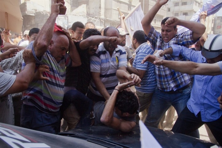 pb-130703-egypt-beating-jsa-815p.photoblog900 An Egyptian opposition protester is beaten by supporters of former Egyptian president Mohammed Morsi, as a man raises a brick overhead, in downtown Damietta, Egypt, on Wednesday. (Hamada Elrasam / AP)