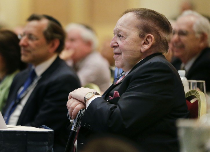 Sheldon Adelson listens as New Jersey Gov. Chris Christie speaks during the Republican Jewish Coalition, Saturday, March 29, 2014, in Las Vegas. Several possible GOP presidential candidates gathered in Las Vegas as Adelson, a billionaire casino magnate, looks for a new favorite to help on the 2016 race for the White House.  (AP Photo/Julie Jacobson)