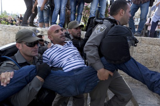 File: A Palestinian man is carried away under arrest by Israeli Police during clashes in East Jerusalem. EPA/JIM HOLLANDER