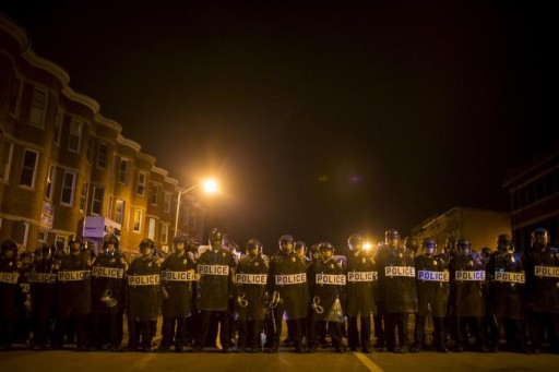 Police line up shortly after the deadline for a city-wide curfew at North Ave and Pennsylvania Ave in Baltimore, Maryland April 30, 2015. REUTERS/Eric Thayer
