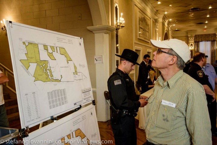 An unidentified man looks up the annexation map before the hearing on June 10, 2015 