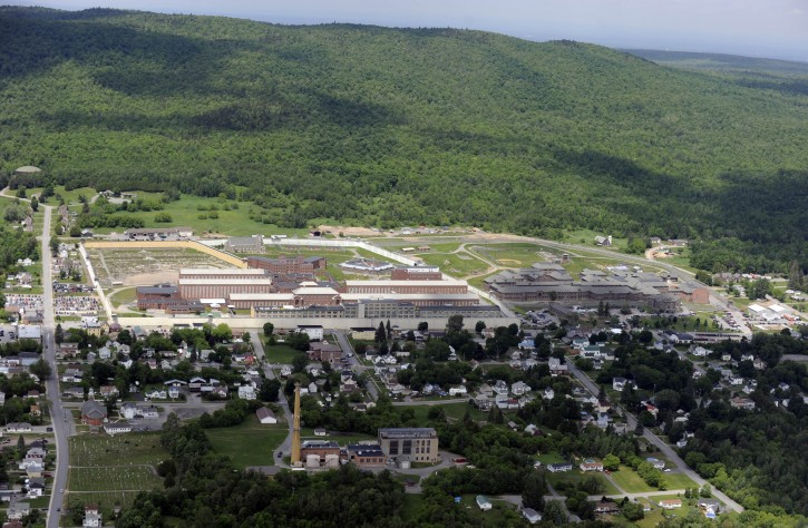 This aerial photo shows the Clinton Correctional Facility on Thursday, June 11, 2015 in Dannemora, N.Y. Police continue to search for David Sweat, 34, and Richard Matt, 48, two escaped inmates from the correctional facility.  In a renewed burst of activity near the prison, police using dogs and helicopters blocked off a main road and concentrated their sixth day of searching Thursday on a swampy area just a couple of miles from the institution, situated about 20 miles (30 kilometers) from the Canadian border. (AP Photo/Tim Roske)