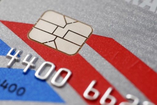 This Wednesday, June 10, 2015 photo shows a chip-based credit card, in Philadelphia. U.S. banks, tired of spending billions a year to pay back fleeced consumers, are in the process of replacing tens of millions of old magnetic strip credit and debit cards with new cards that are equipped with computer chips that store account data more securely. (AP Photo/Matt Rourke)