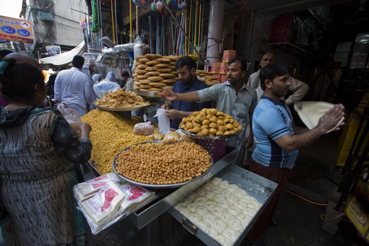 Pakistani customers buy foodstuff ahead of Ramadan in Rawalpindi, Peshawar, Pakistan, Tuesday, June 16, 2015.  Muslims throughout the world mark the month of Ramadan, the holiest month in the Islamic calendar, with dawn to dusk fasting. (AP Photo/B.K. Bangash)