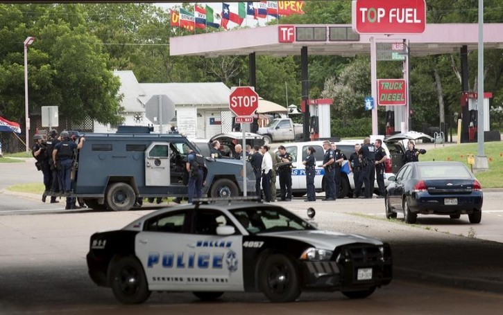 Police vehicles are seen in the city of Hutchins, south of Dallas, Texas June 13, 2015.  Shots were fired from an armored van in an attack on Dallas Police headquarters early on Saturday, police said, and an explosive device was later found outside the building.  REUTERS/Rex Curry