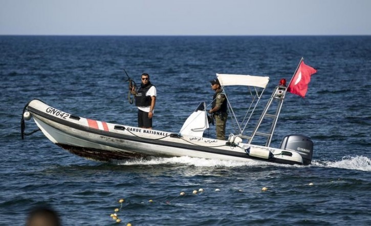 National Guards patrol in a boat in front of the Imperiale Marhaba hotel, which was attacked by a gunman, in Sousse, Tunisia, June 28, 2015. Hundreds of armed police patrolled the streets of Tunisia's beach resorts on Sunday and the government said it will deploy hundreds more inside hotels after the Islamist militant attack in Sousse that killed 39 foreigners, mostly Britons.   REUTERS/Zohra Bensemra