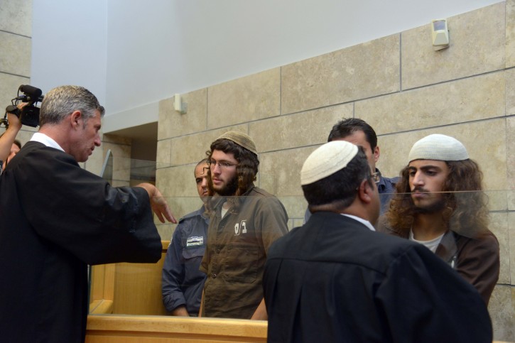 Yinon Reubeni and Yehuda Assaraf, two of the suspects of vandalizing the church of the Multiplication of the Loaves and Fishes in Tabgha, on the shore of the Sea of Galilee last month speaks to their lawyers at the Nazareth Magistrate's Court on July 29, 2015. Photo by Basel Awidat/Flash90