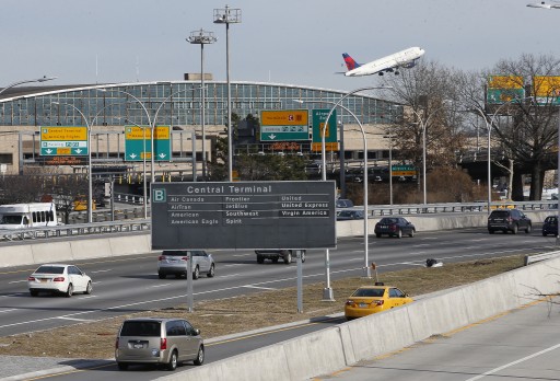 FILE - Cars on the Grand Central Parkway pass LaGuardia Airport in New York, Wednesday, Jan. 21, 2015.   (AP Photo/Kathy Willens)