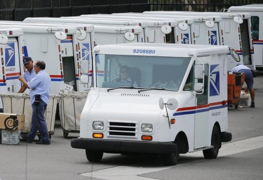 FILE - U.S. postal workers load their trucks with mail for delivery from their postal station in Carlsbad, California February 6, 2013. REUTERS