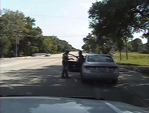 Texas state trooper Brian Encinia points a Taser as he orders Sandra Bland out of her vehicle in this still image captured from the police dash camera video from the traffic stop of Bland's vehicle in Prairie View, Texas, on July 10, 2015.REUTERS