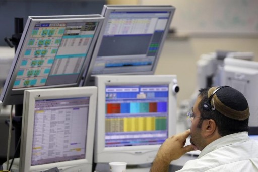 FILE - A trader works in the dealing room of the First International Bank of Israel (FIBI) in Tel Aviv October 7, 2008.REUTERS