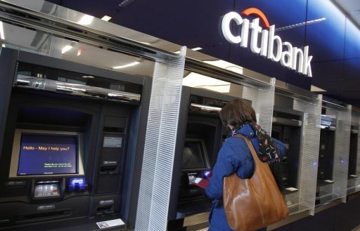 FILE - A woman uses an ATM at Citi's new flagship branch at Union Square in New York, December 16, 2010. REUTERS