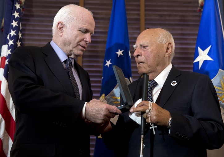 Senate Armed Services Committee Chairman Sen. John McCain, R-Ariz., presents Retired U.S. Air Force 2nd Lt., John R. Pedevillano, 93, of College Park, Md., with the Presidential Unit Citation with one Oak Leaf Cluster during a ceremony on Capitol Hill in Washington, Tuesday, July 7, 2015. Pedevillano served in the U.S. Army Air Corps as the youngest bombardier in the 306th Bomb Group, flew six combat missions and survived being shot down by Nazi fighter pilots. (AP Photo/Carolyn Kaster)