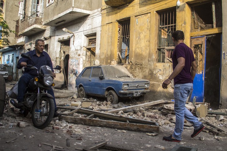 Egyptians in the street outside their damaged houses near the site of a bomb blast at the Italian Consulate in Cairo, Egypt, 11 July 2015.  EPA
