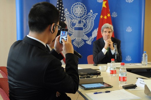 File: Chinese Reporter Takes Photo of U.S. Secretary of State John Kerry. Photo Credit: U.S. State Department)