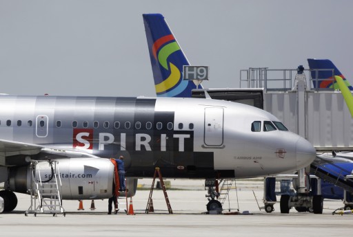 FILE - In this file photo taken June 13, 2010, a Spirit Airlines airplane sits on the tarmac at Fort Lauderdale-Hollywood International Airport in Fort Lauderdale, Fla. Spirit, a low-fare, high-fees carrier with a clientele of mostly leisure travelers, had by far the worst on-time performance in June 2015 among 14 airlines tracked in a government report released Tuesday, Aug. 11, 2015. Only 49.9 percent of its flights arrived within 15 minutes of schedule, which is the government's definition of being on time. (AP Photo/Lynne Sladky, File)