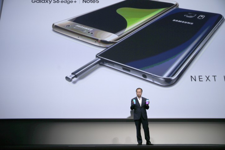 JK Shin, president and CEO of Samsung Electronics holds the Samsung Galaxy S6 Edge Plus, left, and the Samsung Galaxy Note 5 during a presentation, Thursday, Aug. 13, 2015, at Lincoln Center in New York. (AP Photo/Mary Altaffer)