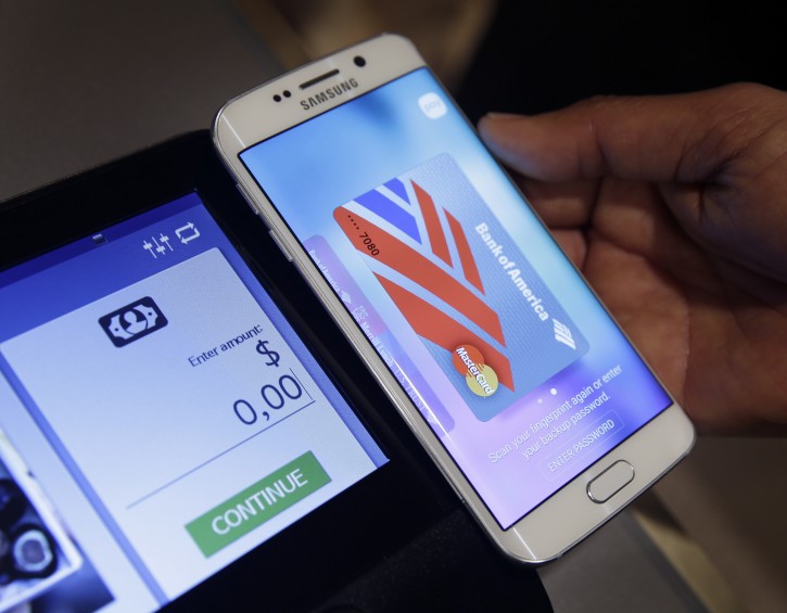 In this Aug. 6. 2015, photo, a Samsung employee demonstrates Samsung Pay using a Galaxy S6 Edge Plus in New York. (AP Photo/Seth Wenig)