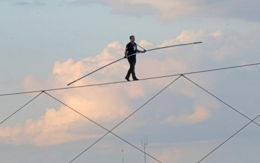 High-wire daredevil Nik Wallenda walks a tightrope above the Milwaukee Mile Speedway at the Wisconsin State Fair in West Allis, Wis. Tuesday, Aug. 11, 2015. Wallenda completed his longest tightrope walk ever during the appearance at the Wisconsin State Fair. (Mike De Sisti/Milwaukee Journal-Sentinel via AP)