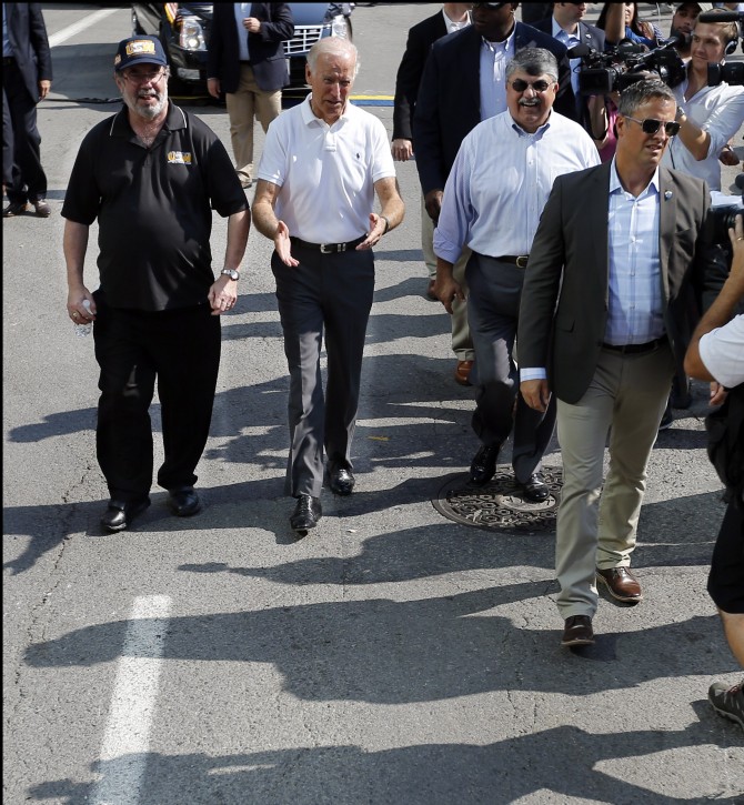 Vice President Joe Biden, center, walks with United Steelworkers President Leo Gerard, left, and AFL-CIO President Rich Trumka as he joins joins in the annual Labor Day parade on Monday, Sept. 7, 2015, in Pittsburgh. (AP Photo/Keith Srakocic)