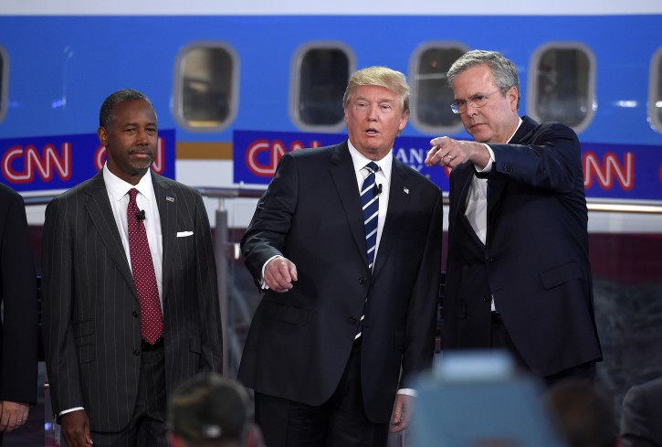 In this photo taken Wednesday, Sept. 16, 2015, Republican presidential candidates, from left, Ben Carson, Donald Trump, and former Florida Gov. Jeb Bush chat during the CNN Republican presidential debate at the Ronald Reagan Presidential Library and Museum in Simi Valley, Calif.   Donald Trumps rivals emerged from the second Republican debate newly confident that the brash billionaire will fade if the primary takes a more substantive turn and that they can play a role in taking him down without hurting their own White House ambitions. Yet in a race that has so far defied standard political logic, that may be little more than wishful thinking.   (AP Photo/Mark J. Terrill)