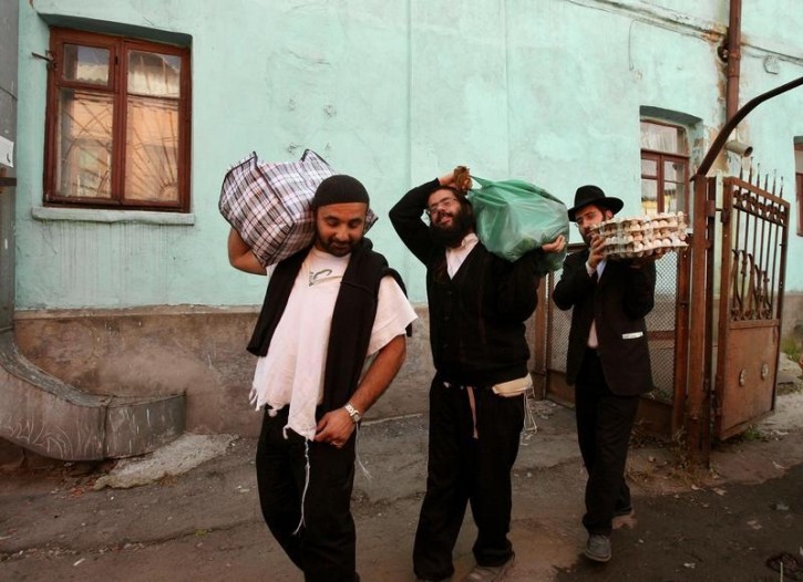 FILE - Ultra orthodox Jews carry food supply for the Jewish holiday of Rosh Hashana near the tomb of Rabbi Nachman of Breslov in the Ukrainian city of Uman. Reuters