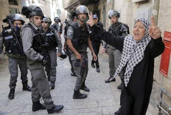 Israeli policemen prevent a Palestinian woman from entering the compound which houses al-Aqsa mosque, known by Muslims as the Noble Sanctuary and by Jews as the Temple Mount, in Jerusalem's Old City September 14, 2015.  Reuters