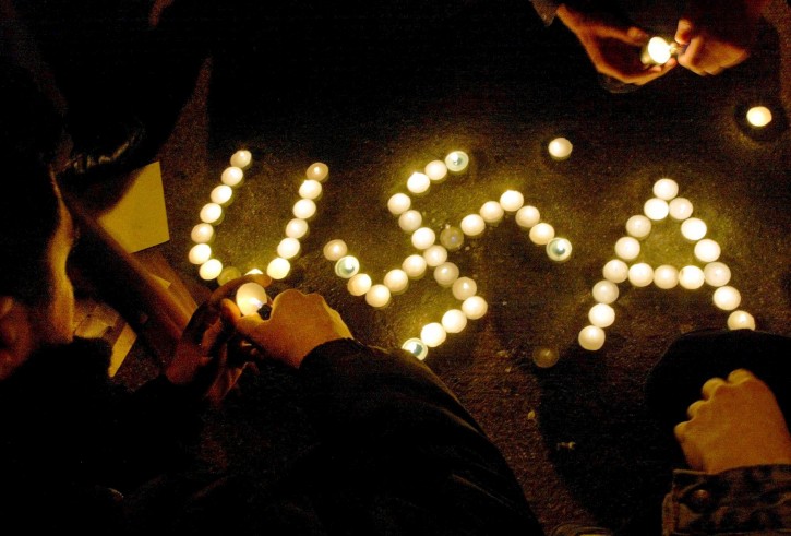 FILE - Protestors, gathered outside the US embassy in Athens, light candles shaping the word USA with the nazi symbol. 20 March 2003. EPA