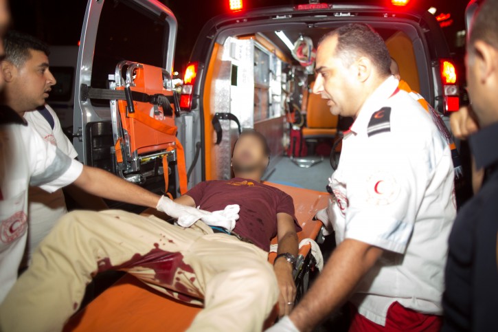 A wounded man is evacuated by ambulance after being stabbed by a Palestinian in an attack in the Old City of Jerusalem on October 3, 2015. A Jewish family and several passersby were stabbed while walking near the Lion's Gate in the Old City. Two victims died of their wounds. The terrorist was shot down by police. Photo by Yonatan Sindel/Flash90 