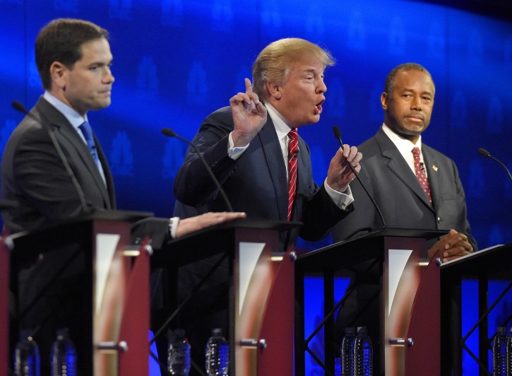 Donald Trump, center, makes a point as Marco Rubio, left, and Ben Carson look on during the CNBC Republican presidential debate at the University of Colorado, Wednesday, Oct. 28, 2015, in Boulder, Colo. (AP Photo/Mark J. Terrill)