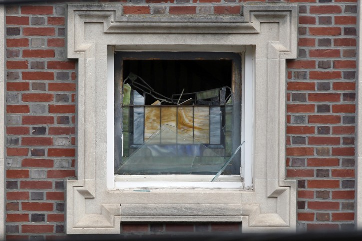 A melted stained glass window is seen in the burned shell of the Poile Zedek Synagogue on Saturday, Oct. 24, 2015, in New Brunswick, N.J.  Authorities say a fire that destroyed the historic New Jersey synagogue on Friday appears to be accidental. (AP Photo/Mel Evans)