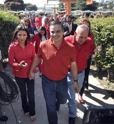 FILE - In this Nov. 18, 2012 file photo, Yani Rosenthal walks with his wife Claudia, after voting in the Liberal Party primary election, in Tegucigalpa, Honduras. The U.S. Justice Department released a statement Wednesday, Oct. 7, 2015, saying that Jaime Rolando Rosenthal Oliva, his son Yani Benjamin Rosenthal and nephew Yankel Rosenthal, as well as seven businesses were labelled specially designated narcotics traffickers under the Kingpin Act. (AP Photo/Fernando Antonio, File)