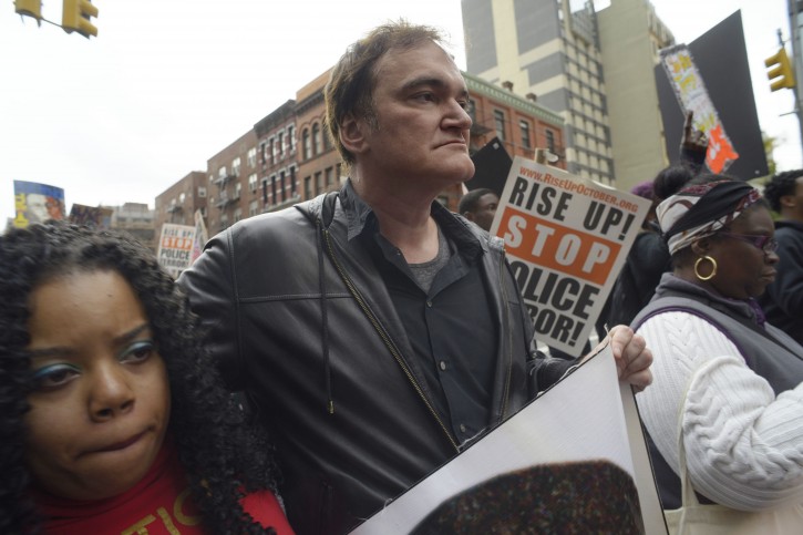 FILE - Director Quentin Tarantino, center, participates in a rally to protest against police brutality Saturday, Oct. 24, 2015, in New York. Speakers at the protest said they want to bring justice for those who were killed by police. (AP Photo/Patrick Sison)