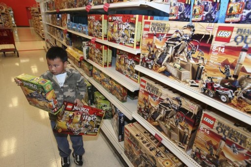 FILE - A boy tries to choose between two Lego sets while shopping  in San Leandro, California December 26, 2011. REUTERS