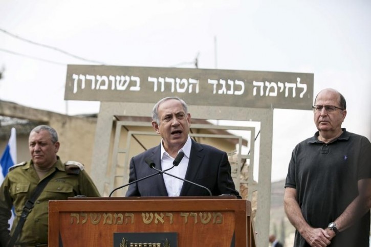 Israeli Prime Minister Benjamin Netanyahu (C) speaks to the media together with , Defence Minister Moshe Ya'alon (R) and Chief of Staff Lieutenant General Gadi Eizenkot (L) in an army base near the West Bank city of Nablus, October 6, 2015. Reuters