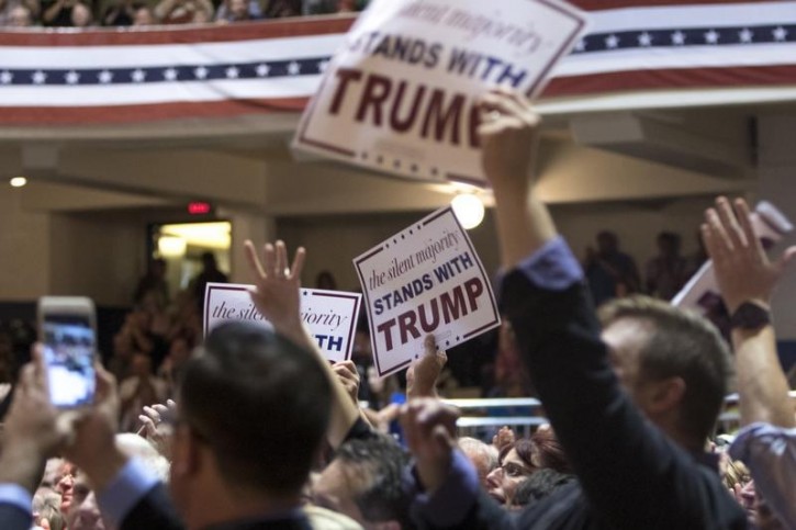 Supporters cheer as Republican presidential candidate Donald Trump speaks during a campaign rally at Burlington Memorial Auditorium in Burlington, Iowa, October 21, 2015. REUTERS/Scott Morgan