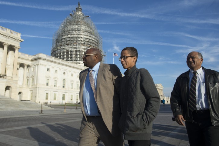 Ahmed Mohamed (C), a 14-year-old student from Irving, Texas, who was arrested after he brought a homemade clock to his high school to show his teachers and was later accused of having a bomb; walks with his father Mohamed Elhassan Mohamed (R) and spokesperson Ron Price (L) following a media event on Capitol Hill in Washington DC, USA, 20 October 2015. Ahmed Mohamed spoke to members of the news media regarding racial profiling.  EPA/MICHAEL REYNOLDS