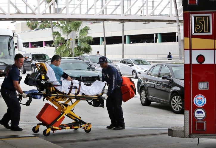 An unidentified passenger from the Dynamic International Airways Boeing 767 airplane that caught fire while taxiing for takeoff, is carried on a stretcher at Fort Lauderdale-Hollywood International Airport in Fort Lauderdale, Florida, USA, 29 October 2015. The left engine of the Caracas, Venezuela bound jet was reported to have caught fire. At least seven people were injured during the evacuation of the 115 passengers and crew.  EPA/CRISTOBAL HERRERA