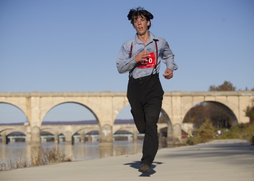 In this photo taken on Sunday, Nov. 8, 2015, Leroy Stolzfus, of Gordonville runs in the 2015 Harrisburg Marathon in Harrisburg, Pa. (Daniel Zampogna /PennLive.com via AP)