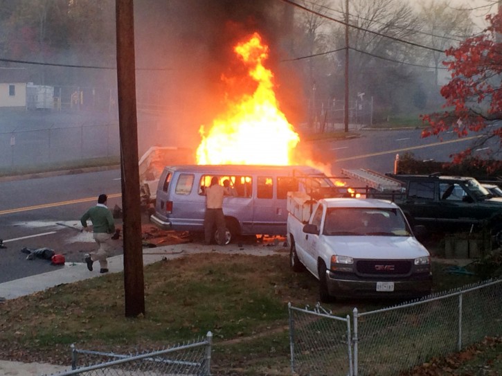 Flames rise from a vehicle following a fatal crash Sunday, Nov. 8, 2015, in Hyattsville, Md. The accident occurred late Sunday afternoon on a road in Hyattsville just northeast of Washington. (Steve Ramsey via AP) 