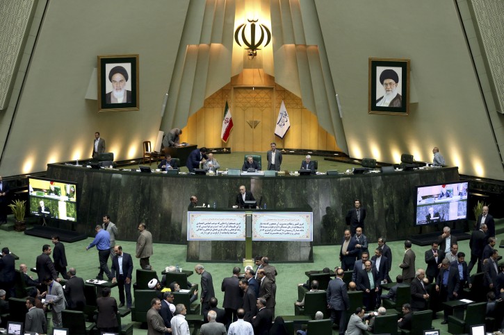 FILE - In this Sunday, Oct. 11, 2015 file photo, the head of Iran's Atomic Energy Organization Ali Akbar Salehi, center, ends his speech in an open session of parliament while discussing a bill on Iran's nuclear deal with world powers, in Tehran, Iran. (AP Photo/Ebrahim Noroozi, File)
