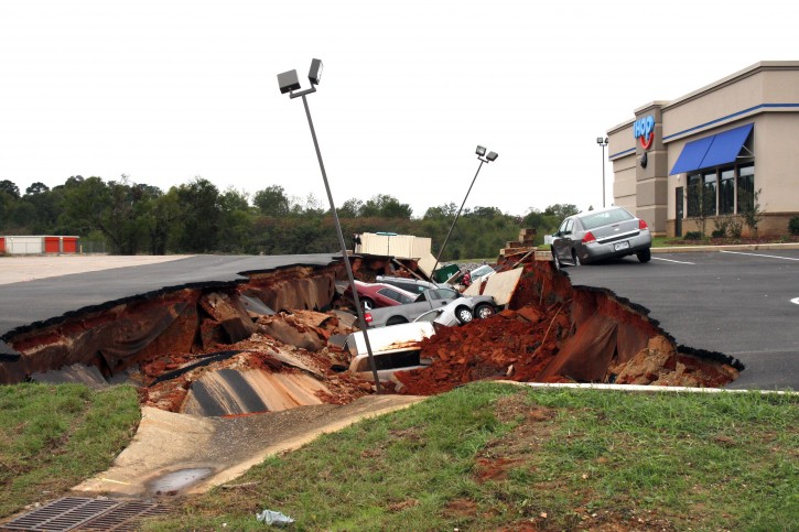 This photo shows vehicles after a cave-in of a parking lot in Meridian, Miss., Sunday, Nov. 8, 2015. Experts are to begin work Monday seeking to determine the cause of the Saturday collapse, authorities said. (Michael Stewart/The Meridian Star via AP) 