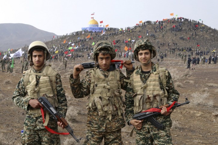 In this Friday, Nov. 20, 2015 photo released by the Fars News Agency, members of the Basij, the paramilitary unit of Iran's Revolutionary Guard, pose for a picture during a military exercise outside the holy city of Qom, central Iran. Thousands of paramilitary forces from Iran's powerful Revolutionary Guard have held a war game simulating the capture of Jerusalem's Al-Aqsa Mosque from Israeli control, state media reported Saturday. (AP Photo/Fars News Agency, Vahid Naderi)