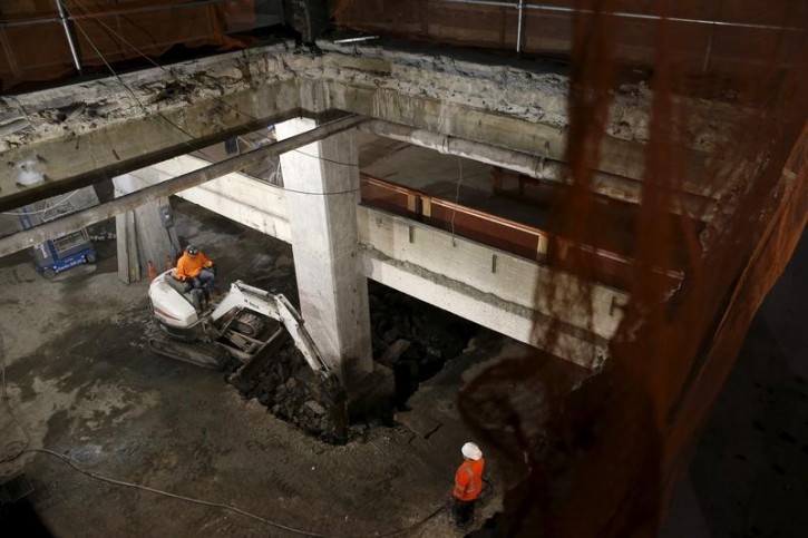 Workers are seen removing concrete in what will be a lobby area inside 390 Madison Avenue, an office building in midtown Manhattan in New York that is undergoing a complete re-construction November 10, 2015.REUTERS