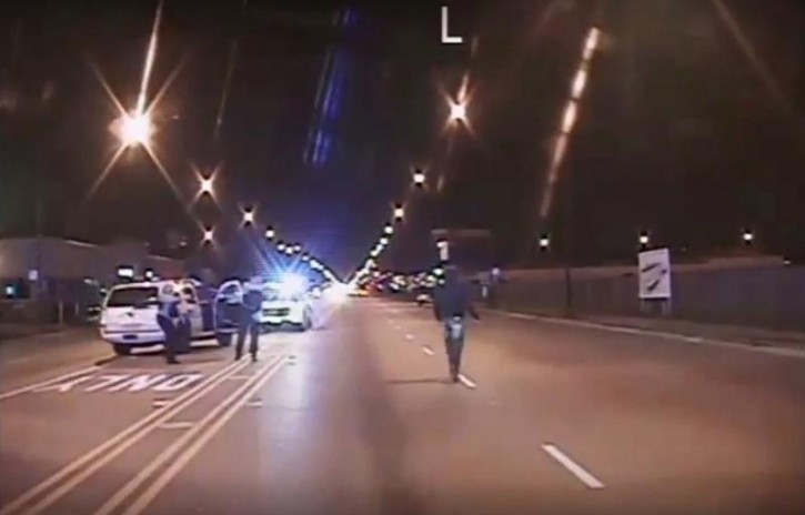 Laquan McDonald (R) walks on a road before he was shot 16 times by police officer Jason Van Dyke in Chicago, in this still image taken from a police vehicle dash camera video shot on October 20, 2014, and released by Chicago Police on November 24, 2015. Van Dyke, a white Chicago policeman was charged on Tuesday with murdering black teenager McDonald, a prosecution that was speeded up in hopes of staving off a fresh burst of the turmoil over race and police use of deadly force that has shaken the U.S. for more than a year. REUTERS/Chicago Police Department/Handout via Reuters  