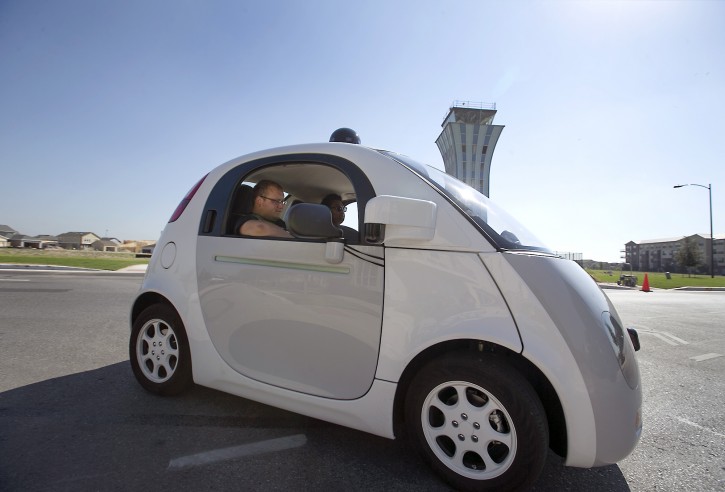 Google's self-driving car tours the Mueller Housing Development, Wednesday, Sept. 23, 2015, in Austin, Texas. Hustling to bring cars that drive themselves to a road near you, Google finds itself somewhere that has frustrated many before: Waiting for help from California's department of motor vehicles. (Ralph Barrera/Austin American-Statesman via AP) 