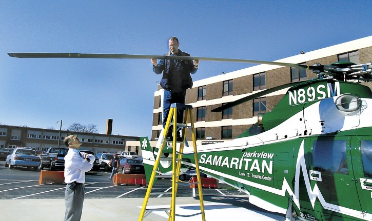 In this Wednesday, April 14, 2004, file photo, Parkview Samaritan helicopter pilot Brad Wilson checks the rotor blade for damage after being struck by a bird while flying, just one mile from Community Hospitals of Williams County, in Bryan, Ohio, the destination landing pad to transport a patient.  (Carla Allshouse/The Bryan Times via AP, File) 