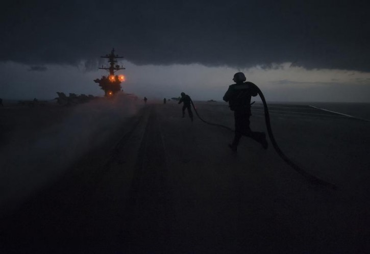 FILE - aircraft carrier USS Carl Vinson passes through a storm in the Arabian Sea. January 21, 2012.  Reuters